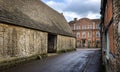 14th Centruy Tithe Barn and The Red Lion Inn in Lacock, Wiltshire, UK Royalty Free Stock Photo