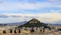 19th century Chapel of St. George on Mount Lycabettus viewed over the rooftops of Athens from the Acropolis with silhouettes o