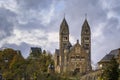 Stone neo romanesque catholic Church of Saints Come and Damien in Clervaux Luxembourg surrounded by a forest in the fall