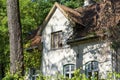 19th century house with tiled roof window. Front facade details, Beautiful old cottage in the forest Royalty Free Stock Photo