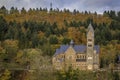 Stone neo romanesque catholic Church of Saints Come and Damien in Clervaux Luxembourg surrounded by a forest in the fall