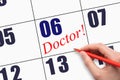 6th day of the month. Hand writing text DOCTOR on calendar date.