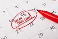 15th day of month marked with red circle. The phrase pay off Credit cards, written in red text on a calendar page as a reminder. Royalty Free Stock Photo