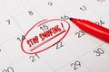 15th day of month marked with red circle. The phrase Stop smoking, written in red text on a calendar page as a reminder. Closeup Royalty Free Stock Photo