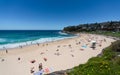 People enjoying hot sunny summer day on Bronte beach and swimming in the sea in Sydney NSW Australia Royalty Free Stock Photo