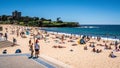 People enjoying hot sunny summer day on Coogee beach in Sydney NSW Australia Royalty Free Stock Photo