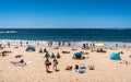 People enjoying hot sunny summer day on Coogee beach in Sydney NSW Australia Royalty Free Stock Photo