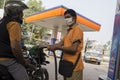 12th December, 2021, Narendrapur, West Bengal, India: A petrol pump employee refueling a two wheeler