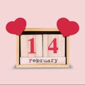 14th of February. Wooden calendar with red hearts on a pink background. Valentine`s day background.