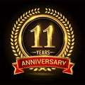 11th golden anniversary logo, with shiny ring and red ribbon, laurel wreath isolated on black background, vector design