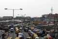 Editorial image of a street near ijora,lagos showing people and yellow buses Royalty Free Stock Photo