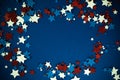 4th of July American Independence Day stars decorations frame on blue background. Flat lay, top view. Royalty Free Stock Photo