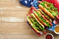 4th of July American Independence Day traditional picnic food. Hot dog with potato chips and cocktail, American flags and symbols Royalty Free Stock Photo