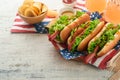 4th of July American Independence Day traditional picnic food. Hot dog with potato chips and cocktail, American flags and symbols Royalty Free Stock Photo