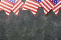 4th of July background. USA paper fans, Red, blue, white stars, balloons, gold confetti on gray dark concrete background. Happy Royalty Free Stock Photo