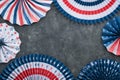 4th of July background. USA paper fans, Red, blue, white stars, balloons, gold confetti on gray dark concrete background. Happy Royalty Free Stock Photo