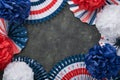 4th of July background. USA paper fans, Red, blue, white stars, balloons, gold confetti on gray dark concrete background. Happy Royalty Free Stock Photo
