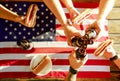 Holiday composition with multiple bottles of beer and hot dogs, American flag. Group of people celebrating Independence day of USA Royalty Free Stock Photo