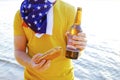 Holiday composition with multiple bottles of beer and hot dogs, American flag. Celebrating the Independence day of USA. Royalty Free Stock Photo