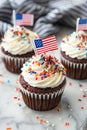 4th of july chocolate cupcakes with cream cheese and eeuu flag on top on wooden table