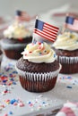4th of july chocolate cupcakes with cream cheese and eeuu flag on top on wooden table