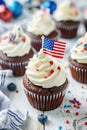 4th of july chocolate cupcakes with cream cheese and eeuu flag on top on wooden table