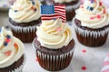 4th of july chocolate cupcakes with cream cheese and eeuu flag on top on wooden table
