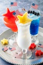 4th of July cocktails garnished with patriotic flags and fruit stars.