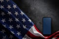 4th of July or Memorial Day of United States Concept. Blank Mobile Screen for Mockup. USA Flag Lying on Cement Background. Royalty Free Stock Photo