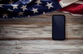 4th of July or Memorial Day of United States Concept. Blank Mobile Screen for Mockup. USA Flag Lying on Wooden Background. Royalty Free Stock Photo