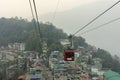 28th March, 2021, Gangtok, Sikkim, India: Tourists enjoying a rope way cable car or Gondola ride over Gangtok city during sunset. Royalty Free Stock Photo