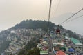 Tourists enjoying a rope way cable car or Gondola ride over Gangtok city during sunset. Amazing aerial view of Sikkim Royalty Free Stock Photo