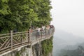 28th of May, 2018: Tourists preparing to have their pictures taken at the Cliff Glass Sky Walk at Tianmen Mountain, The Heaven`s