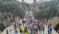 30th of May: Tourists walking and taking pictures in a rainy day at the Glass Bridge Grand Canyon, Wulingyuan, Zhangjiajie Nationa