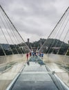 30th of May: Tourists walking and taking pictures in a rainy day at the Glass Bridge Grand Canyon, Wulingyuan, Zhangjiajie Nationa