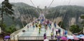 30th of May: Tourists walking and taking pictures in a rainy day at the Glass Bridge Grand Canyon, Wulingyuan, Zhangjiajie Nationa