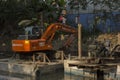 17th November, 2021, Narendrapur, West Bengal, India: A JCB machine doing dazing at a little channel at Kolkata