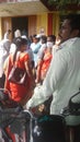 Group of people, male and female waiting outside of Indian hospital