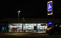 26th of September - Aldi supermarket at night time, with car passing by, ready for the grand opening on 28th of September 2023 in