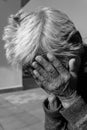 28th september 2020. Uttarakhand, India. A black and white shot of an old Indian lady having her wrinkled hands over her face in Royalty Free Stock Photo