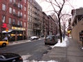 51th Street, near the Intersection with 8th ave, in New York City during winter daytime against a cloudy sky