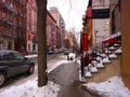 51th Street, near the Intersection with 8th ave, in New York City during winter daytime against a cloudy sky