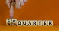 From 4th to 1st quater symbol. Businessman turns cubes and changes words `4th quater` to `1st quater`. Beautiful orange table,