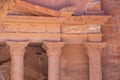 Up close facade of red rose-colored Treasury of Petra, Jordan