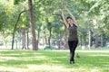 Thai adult beautiful girl doing yoga exercises in the park Royalty Free Stock Photo