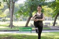 Thai adult beautiful girl doing yoga exercises in the park Royalty Free Stock Photo