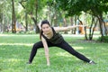 Thai adult beautiful girl doing yoga exercises in the park Royalty Free Stock Photo