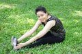 Thai adult beautiful girl doing yoga exercises in the park Royalty Free Stock Photo