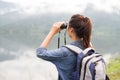 Thai adventure girl wathcing with binoculars