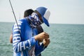 Thai angler or fisherman use fishing-rod fishing fish in the sea Royalty Free Stock Photo